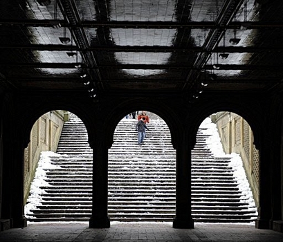 Tourist make their way down icy steps near the Bethesda Fountain ...