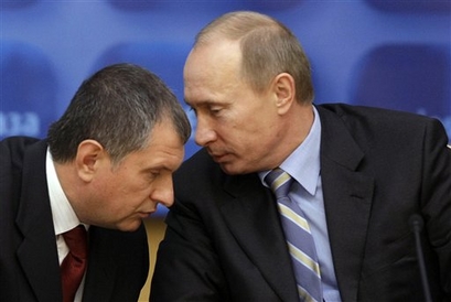 Russia's Prime Minister Vladimir Putin speaks  with Igor Sechin, ...