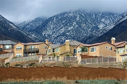 Storm clouds hover near recently finished homes and unfinished ...